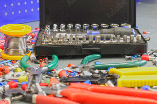 Universal tool box, tool kit closeup with set of hex, torx and screwdriver bits, and various sizes of ratchet wrench sockets photo