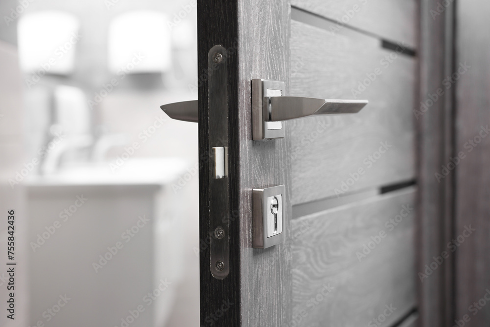 Open wooden door with metal handle, closeup Open wooden door with metal handle, closeup