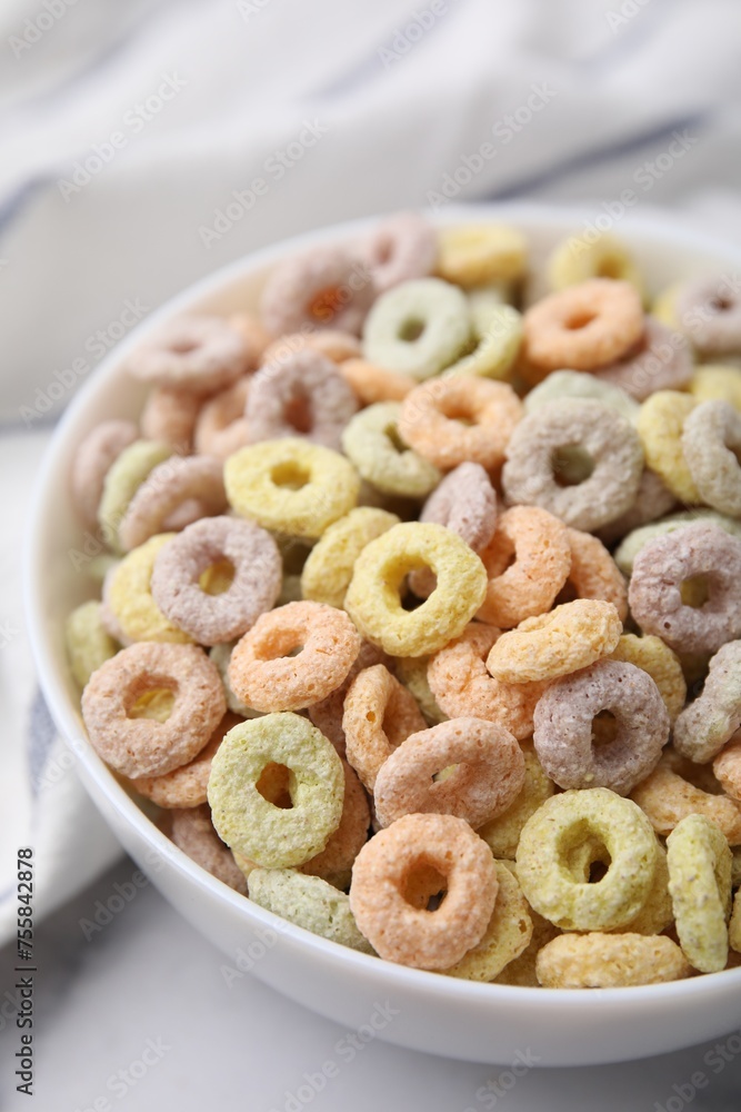Tasty cereal rings in bowl on white table, closeup Tasty cereal rings in bowl on white table, closeup
