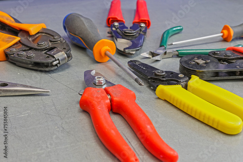Electrical installation tools for installation of electrical panels. On a metal surface. Close-up.