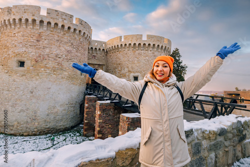 Happy tourist girl at the Zindan gate entrance to Kalemegdan fortress. Travel attractions and destinations in Belgrade