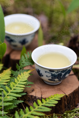 Two cups of green tea on wooden stands