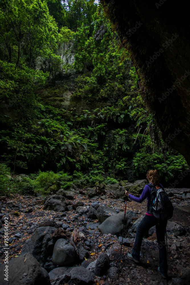 Fototapeta premium A young woman in Tilos waterfall, La Palma Island, Canary Islands.