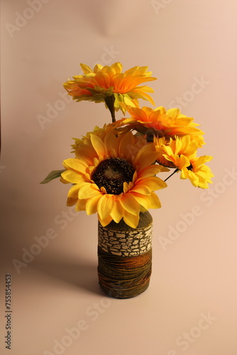 Yellow sunflowers in textured green vase.