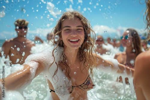 A woman is in the ocean with her friends, and she is smiling. Summer foam party concept