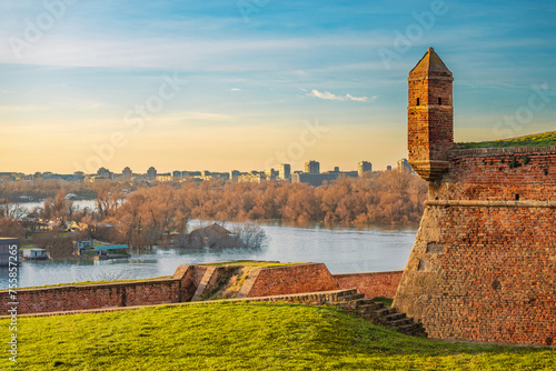 golden hues of sunset atop Belgrade's Kalemegdan fortress, where visitors are greeted by historic battlements and panoramic views of the Danube.