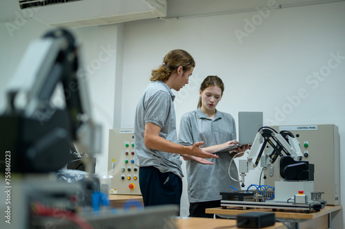 Trainee Robotics engineer learning with Programming and Manipulating Robot Hand, Industrial Robotics Design, High Tech Facility, Modern Machine Learning. Mass Production Automatics.