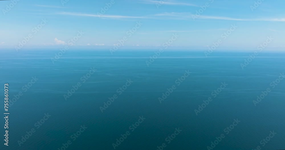 Beautiful white clouds on blue sky over calm sea. Flight over the sea. Indonesia. Beautiful white clouds on blue sky over calm sea. Flight over the sea. Indonesia.