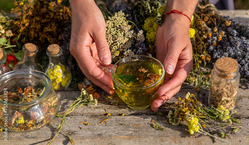 A woman brews herbal tea. Selective focus.