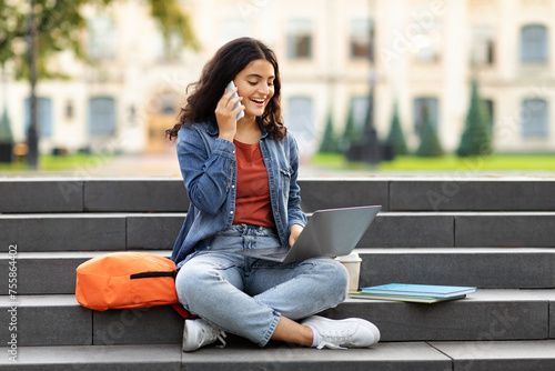фотографія Young eastern woman student doing homework, calling her classmate