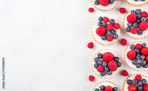 Sweet dessert - cupcakes and fresh berries on white background, copy space