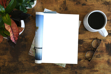An open magazine laying on a table or desk with a white blank page for mock up.