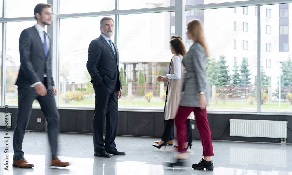 Business people at work in a busy office space. Business people at work in a busy office space.