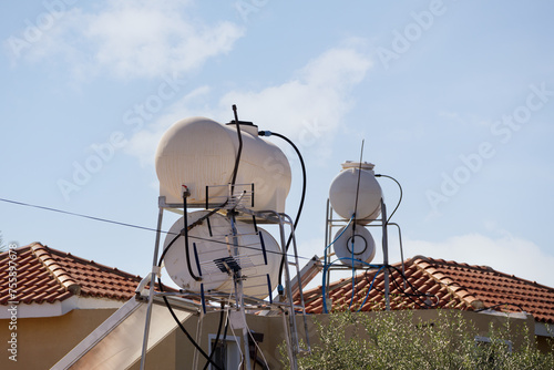 Solar heated water boilers on the roof of the house. Water heating boilers © Armands photography