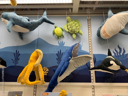 shop display of blue and white and yellow and green stuffed animals