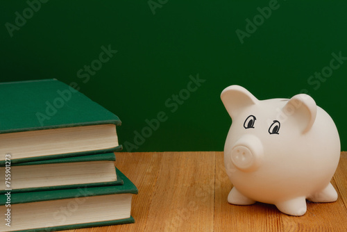 Saving money for education with piggy bank
