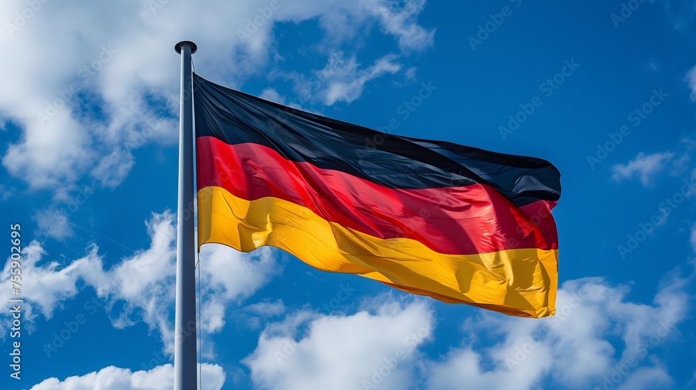 Germany flag waving in the wind on blue sky with clouds background Germany flag waving in the wind on blue sky with clouds background
