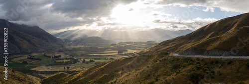 Beautiful panoramic vista of valley surrounded by mountains with soft after storm light, New Zealand