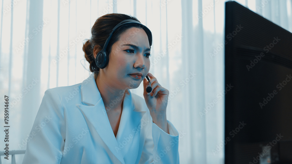 Businesswoman wearing headset working in office to support remote customer or colleague. Frustrated and tired call center customer support agent facing problem on providing vivancy service - obrazy, fototapety, plakaty 