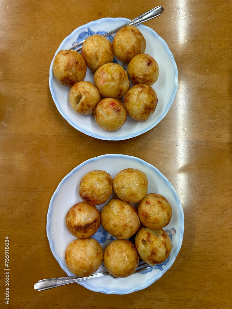 Takoyaki is a popular snack in Osaka. Takoyaki Japanese food octopus balls. Directly above. Takoyaki is a popular snack in Osaka. Takoyaki Japanese food octopus balls. Directly above.