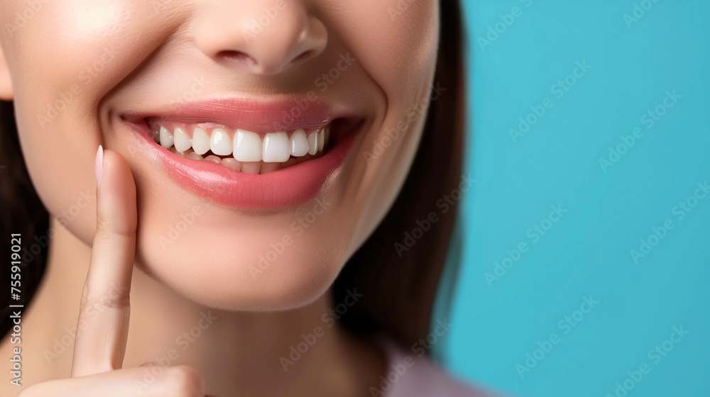Obraz premium Dentistry, Woman with beautiful teeth. Close-up photo. Woman with beautiful teeth. Pointing finger at his own bright smile. Advertising image.
