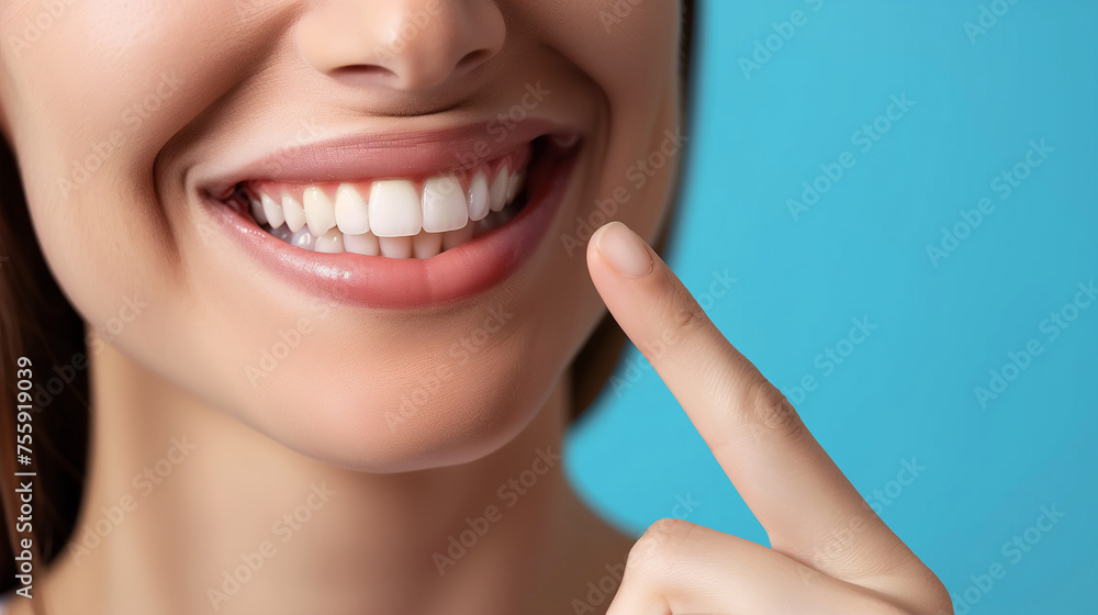 Obraz premium Dentistry, Woman with beautiful teeth. Close-up photo. Woman with beautiful teeth. Pointing finger at his own bright smile. Advertising image.