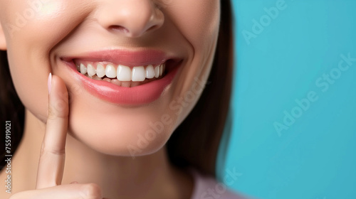 Dentistry, Woman with beautiful teeth. Close-up photo. Woman with beautiful teeth. Pointing finger at his own bright smile. Advertising image.