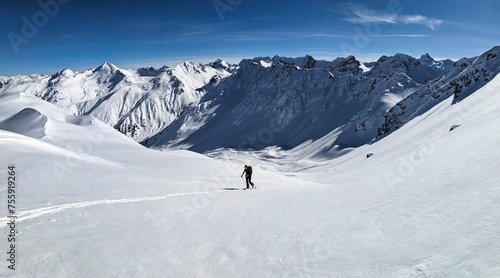 first line ski tour. Ski tourers fight their way through the untouched deep snow towards the summit. Büelenhorn Davos Monstein. Ski mountaineering in the Graubünden mountains. Ski track skitour.