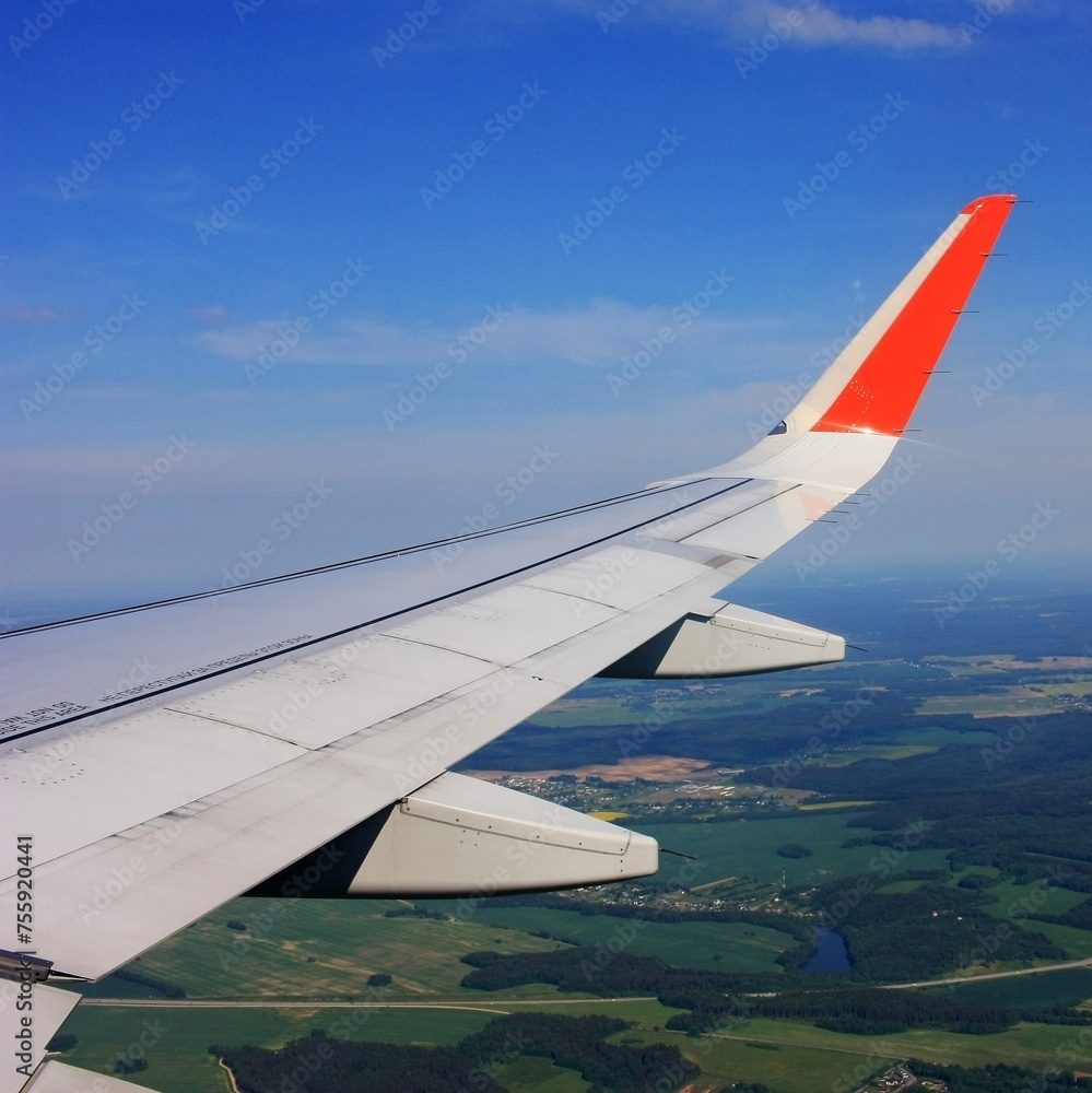 Airplane wing in blue sky with clouds Airplane wing in blue sky with clouds