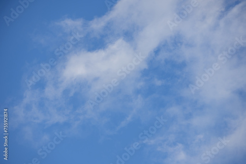 A blue sky landscape with some diffuse clouds