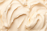 Close-up of smooth, creamy, white whipped cream texture with soft swirls.