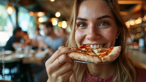 Close up of a young woman eating pizza in a cafe