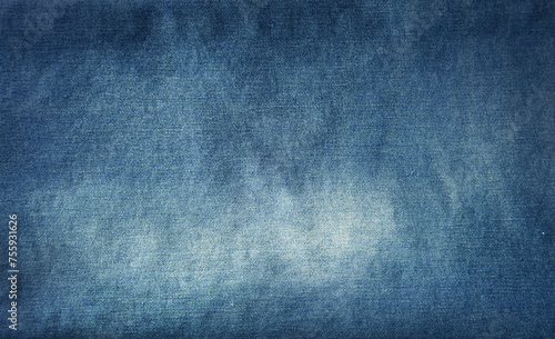 Close-up of faded blue denim jeans fabric texture background