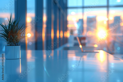 Modern office interior with sunset reflections on glass walls