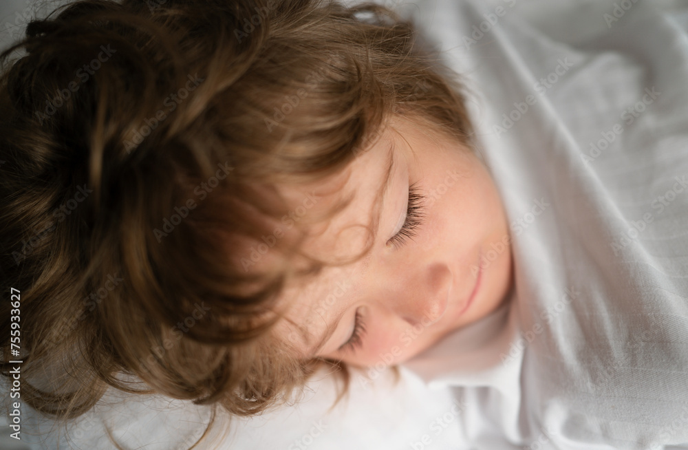 Kids sleeping alone in comfortable bed with white linens. Kids sleeping alone in comfortable bed with white linens.