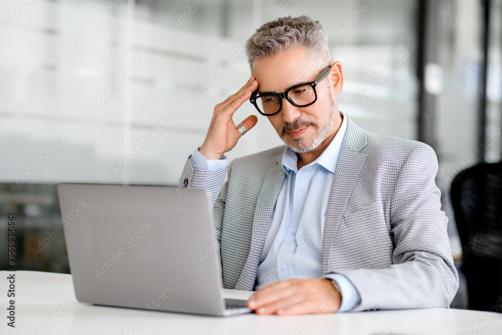 Mature businessman is deeply focused on his laptop screen in a serene office setting, embodying the concentration and strategic thought that drives business success, a moment of deep analysis Mature businessman is deeply focused on his laptop screen in a serene office setting, embodying the concentration and strategic thought that drives business success, a moment of deep analysis
