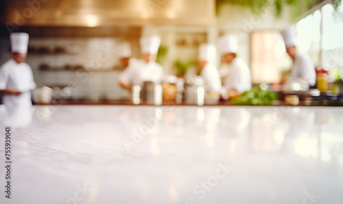 Empty white marble table background  chefs working in professional restaurant kitchen  copy space