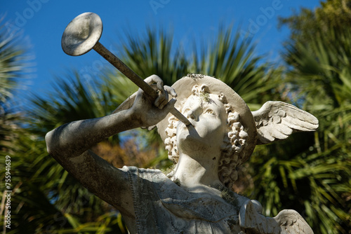 Statue of Mercury (Hermes) god of commerce, merchant and travelers.  Blowing a horn with wings on his hat outside. photo