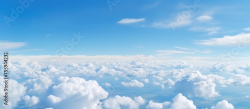 Wallpaper Mural Viewing the fluid landscape of electric blue sky filled with cumulus clouds from an airplane window, a mesmerizing meteorological phenomenon Torontodigital.ca