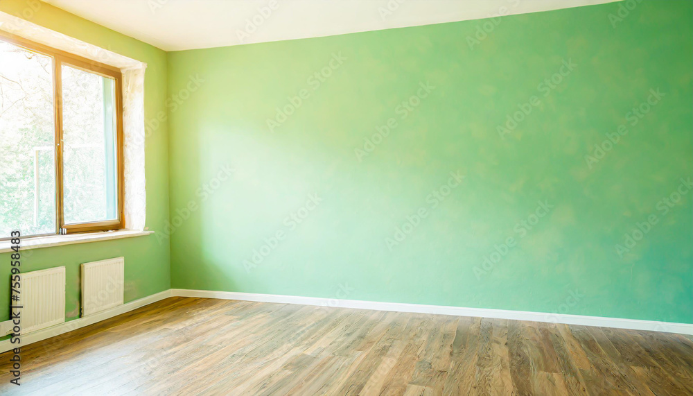 Light green wall in an empty room with a wooden floor Light green wall in an empty room with a wooden floor