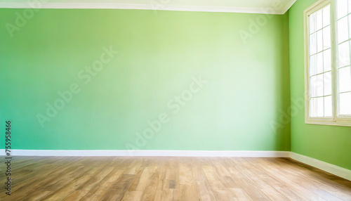 Light green wall in an empty room with a wooden floor © netsay