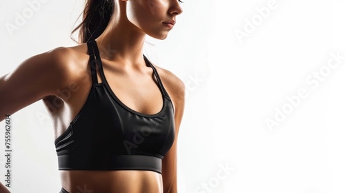 A woman in a sports bra top posing for a picture. Suitable for fitness and health concepts.