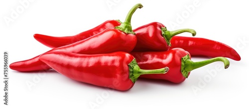 A variety of red peppers, including Birds eye chili, Italian sweet pepper, Chile de rbol, Malagueta pepper, on a white background. These natural foods are common ingredients in spicy dishes photo