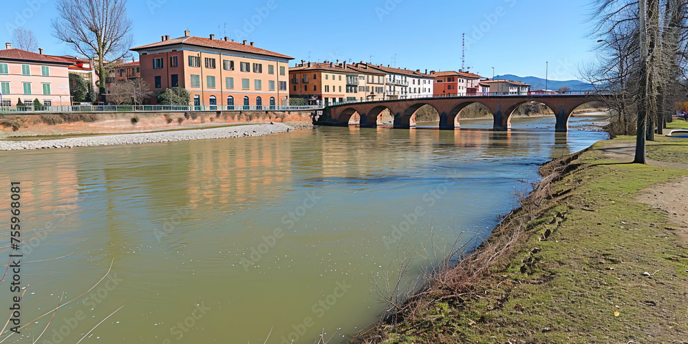 Fototapeta premium A bridge spans over a body of water, with buildings visible in the background