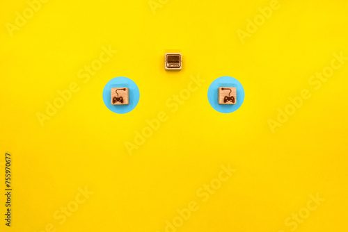 コントローラーのアイコンが2つ並ぶ黄色い背景のテレビゲームのイメージ photo