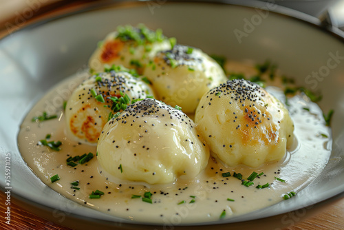 Yeast dumplings with vanilla sauce sprinkled with poppy seed.