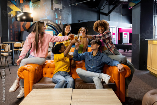 Diverse Group of Friends Celebrating with Drinks at an Arcade