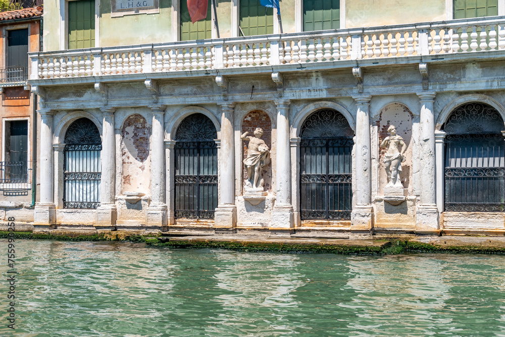 Statues Adorn Venetian Palazzo Alongside Grand Canal
