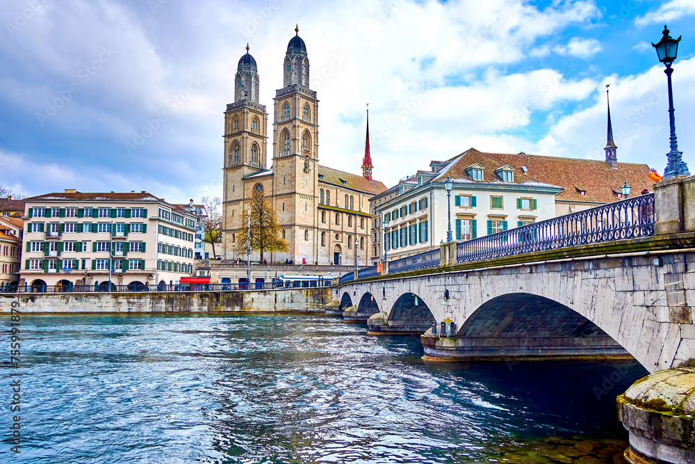 Limmat river and Munsterbrucke bridge with Grossmunster, houses on the river's bank, Zurich, Switzerland