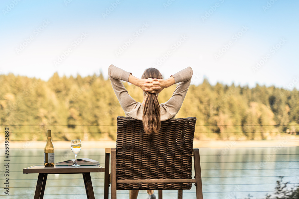 Young happy woman sitting back relaxing enjoying time in nature, wine, book on a summer day - obrazy, fototapety, plakaty 